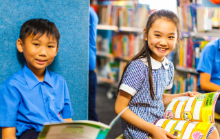 A photo of two St Mel’s Catholic Primary School Campsie students reading in the school library