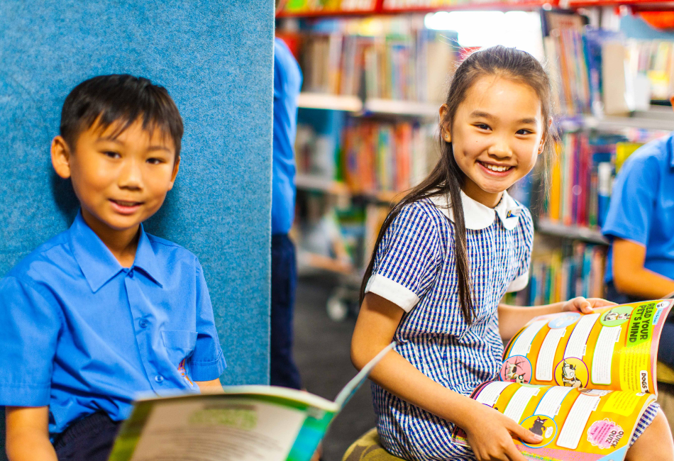 A photo of two St Mel’s Catholic Primary School Campsie students reading in the school library